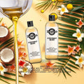 Two bottles of 'Coconut Bliss' fragrance on a decorative background with flowers and leaves.