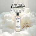 Fragrance bottle labeled 'Clean Cloud' by Peanut Fragrance Co. surrounded by white flowers on a light background.