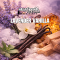 Lavender vanilla fragrance product with vanilla beans, lavender flowers, and amber on a textured background.