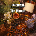 Stayfresh with Peanut Fragrance Co. bottle surrounded by flowers, leaves, and fruits on a dark background.