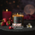 Twilight premium fragrance oil candle with strawberries and a cherry on a dark surface.