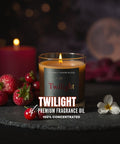 Twilight premium fragrance oil candle with strawberries and a cherry on a dark surface.